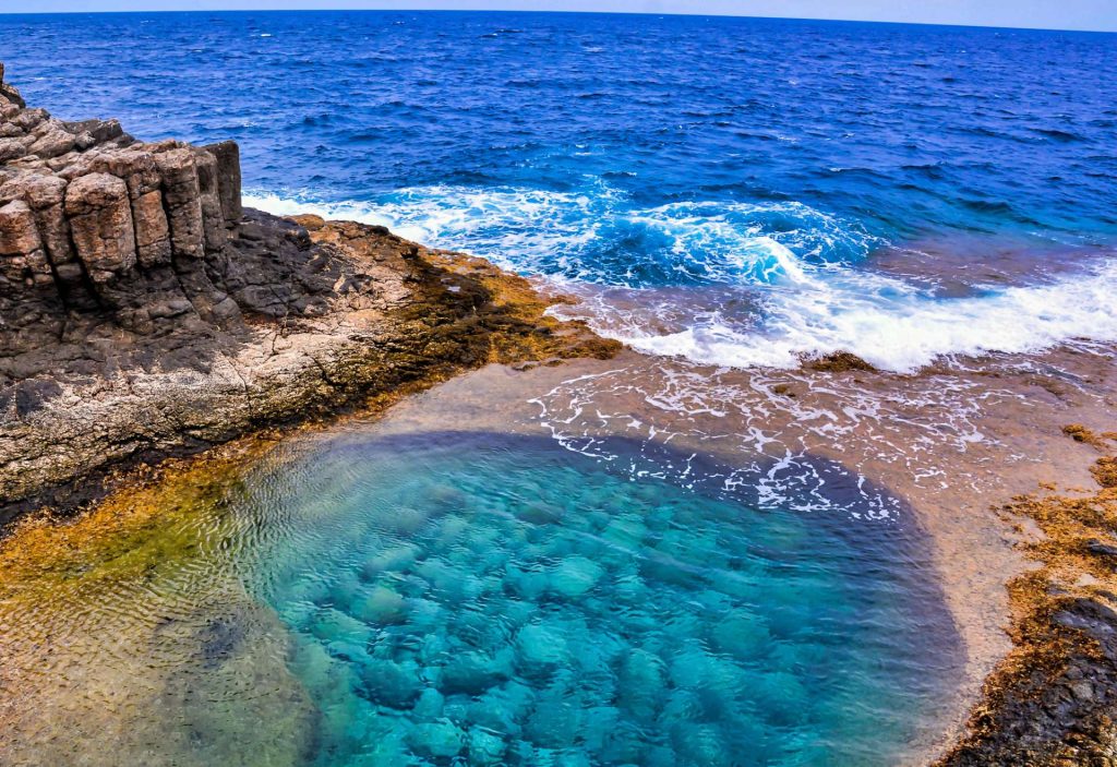 high-angle-shot-beautiful-sea-surrounded-by-rock-formations-canary-islands-spain