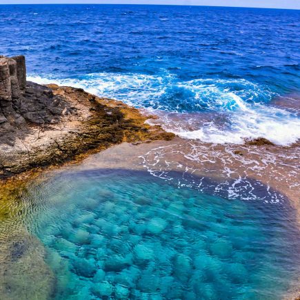 high-angle-shot-beautiful-sea-surrounded-by-rock-formations-canary-islands-spain